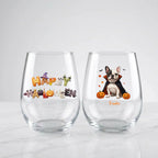 Two personalized Halloween stemless wine glasses on marble, one with 'Happy Halloween' lettering, one with a vampire-costume dog with pumpkins and pet name