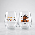 Two personalized Halloween stemless wine glasses on marble, one with 'Happy Halloween' lettering, one with a witch-costume dog with pumpkins and pet name