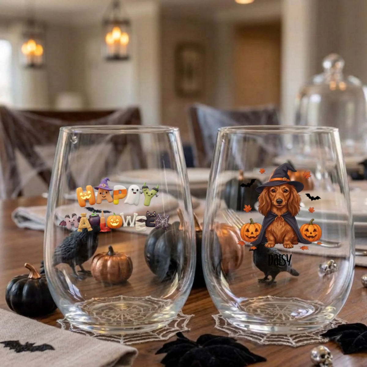 Pair of personalized Halloween stemless wine glasses with a witch-costume dog with pumpkins on a dining table set for a Halloween party