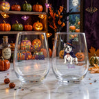 Personalized watercolor witch-costume dog Halloween stemless wine glasses on a windowsill with glowing jack-o-lanterns and fall decor