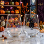 Personalized watercolor vampire-costume dog Halloween stemless wine glasses on a windowsill with glowing jack-o-lanterns and fall decor
