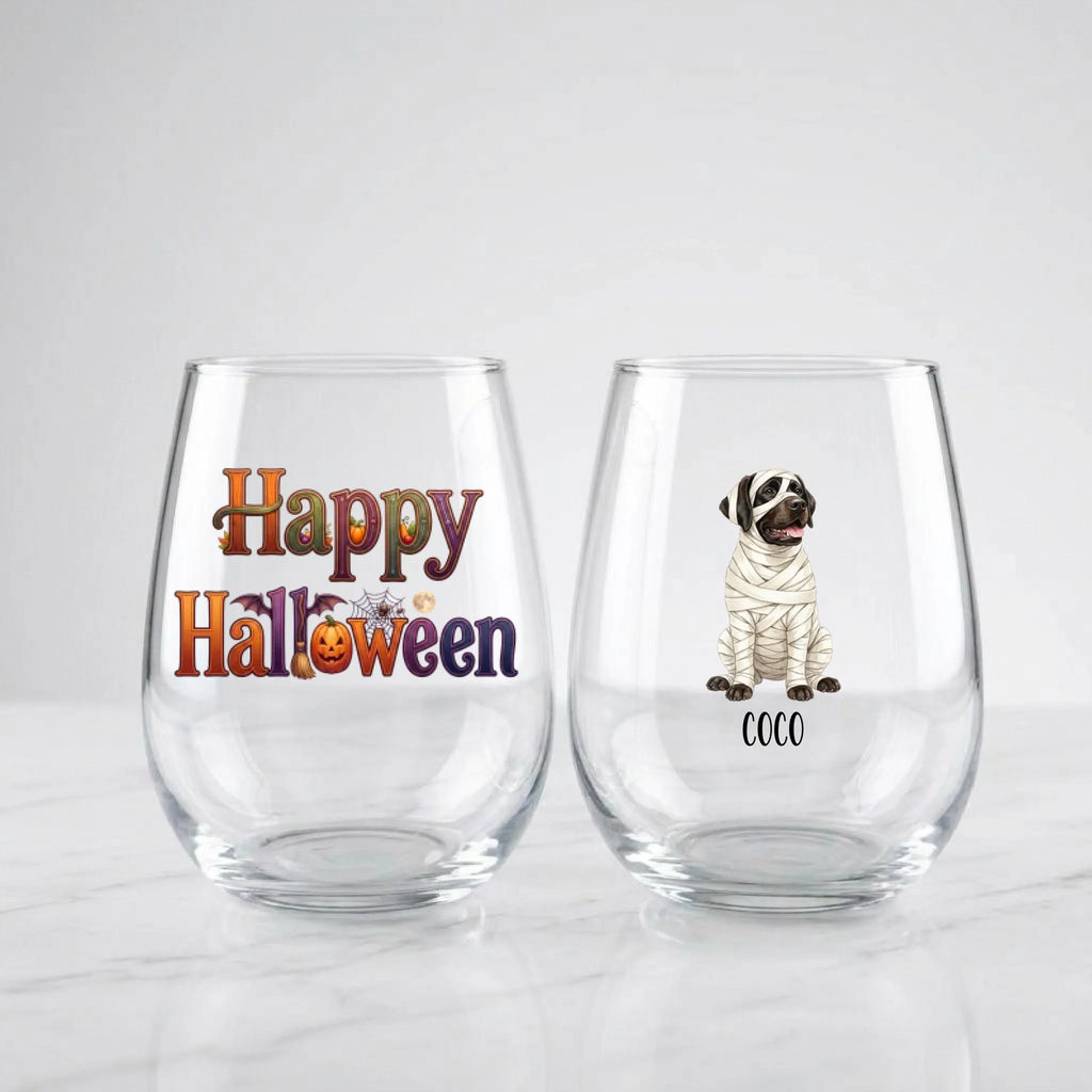Two personalized Halloween stemless wine glasses on marble, one with 'Happy Halloween' lettering, one with a watercolor mummy-costume dog and pet name