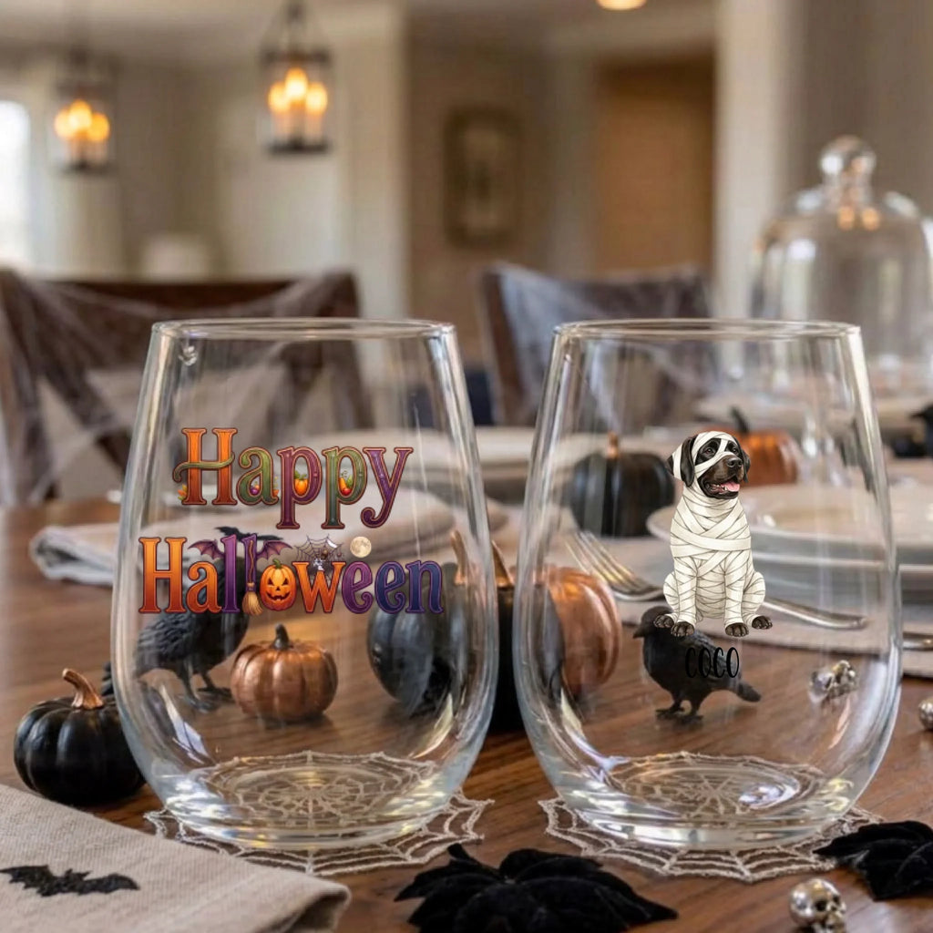Pair of personalized Halloween stemless wine glasses with a watercolor mummy-costume dog on a dining table set for a Halloween party