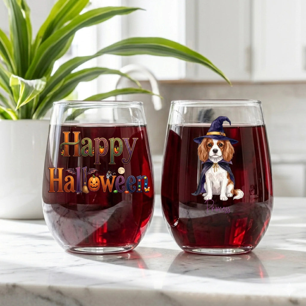 Personalized witch dog stemless wine glasses filled with red wine, Happy Halloween design on marble counter