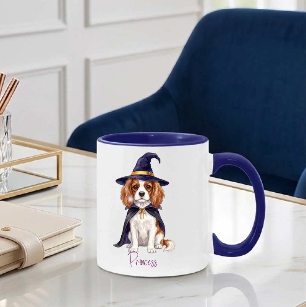 Personalized witch dog Halloween coffee mug with midnight blue handle on a desk beside a blue chair