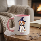 Personalized witch dog Halloween coffee mug with pink handle on a side table by a cozy fireplace