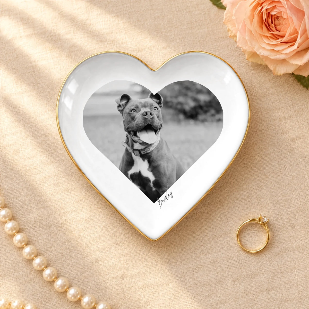 Personalized black and white pet photo on a heart ceramic ring dish with gold rim