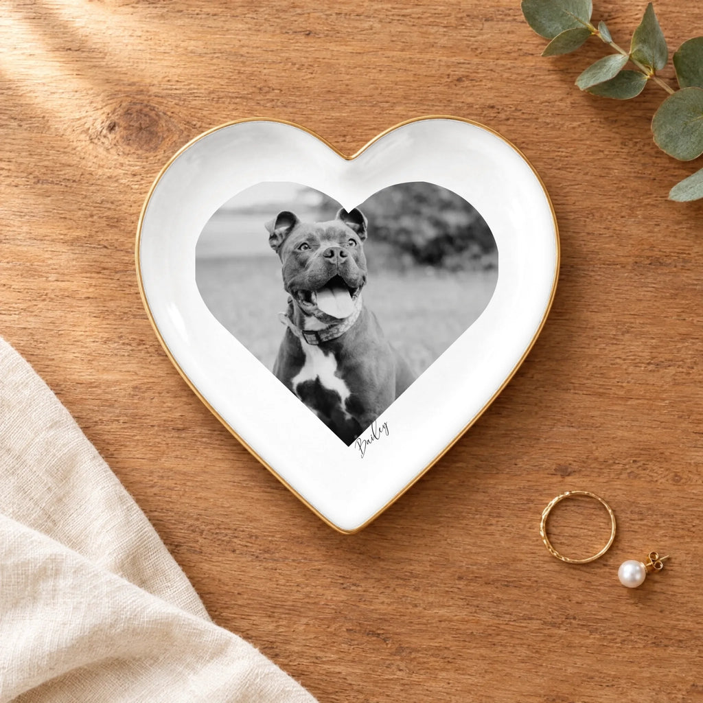 Black and white pet photo heart ring dish on a wooden table with linen and eucalyptus