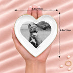 Hand holding a black and white pet photo heart ring dish, 4.3 inches across