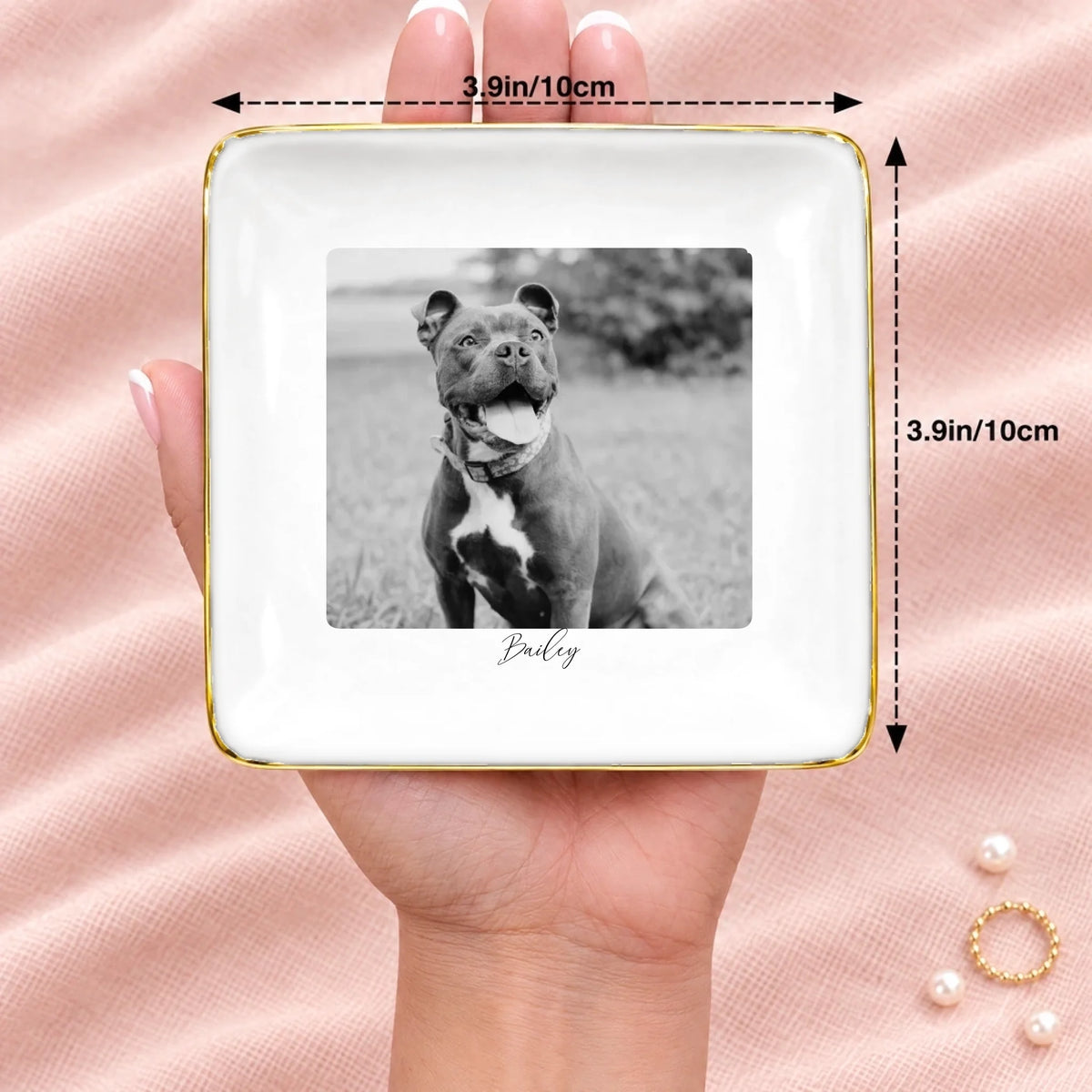 Black and white pet photo square ring dish resting on an open hand, 3.9 inches across