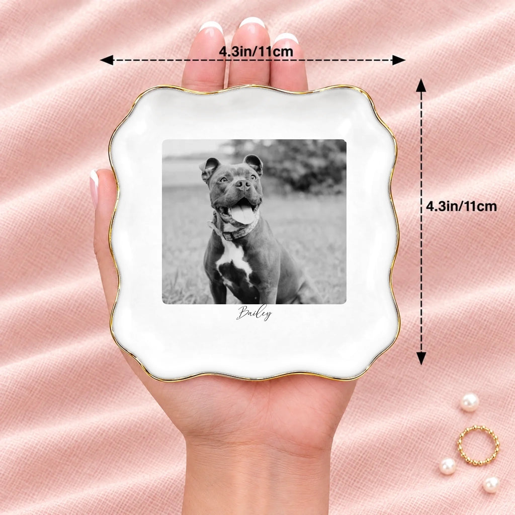 Hand holding a black and white pet photo wavy square ring dish, 4.1 inches across