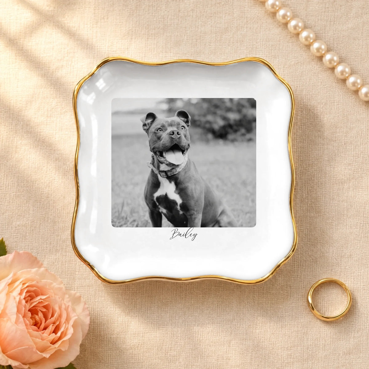 Personalized black and white pet photo on a wavy square ceramic ring dish with gold rim