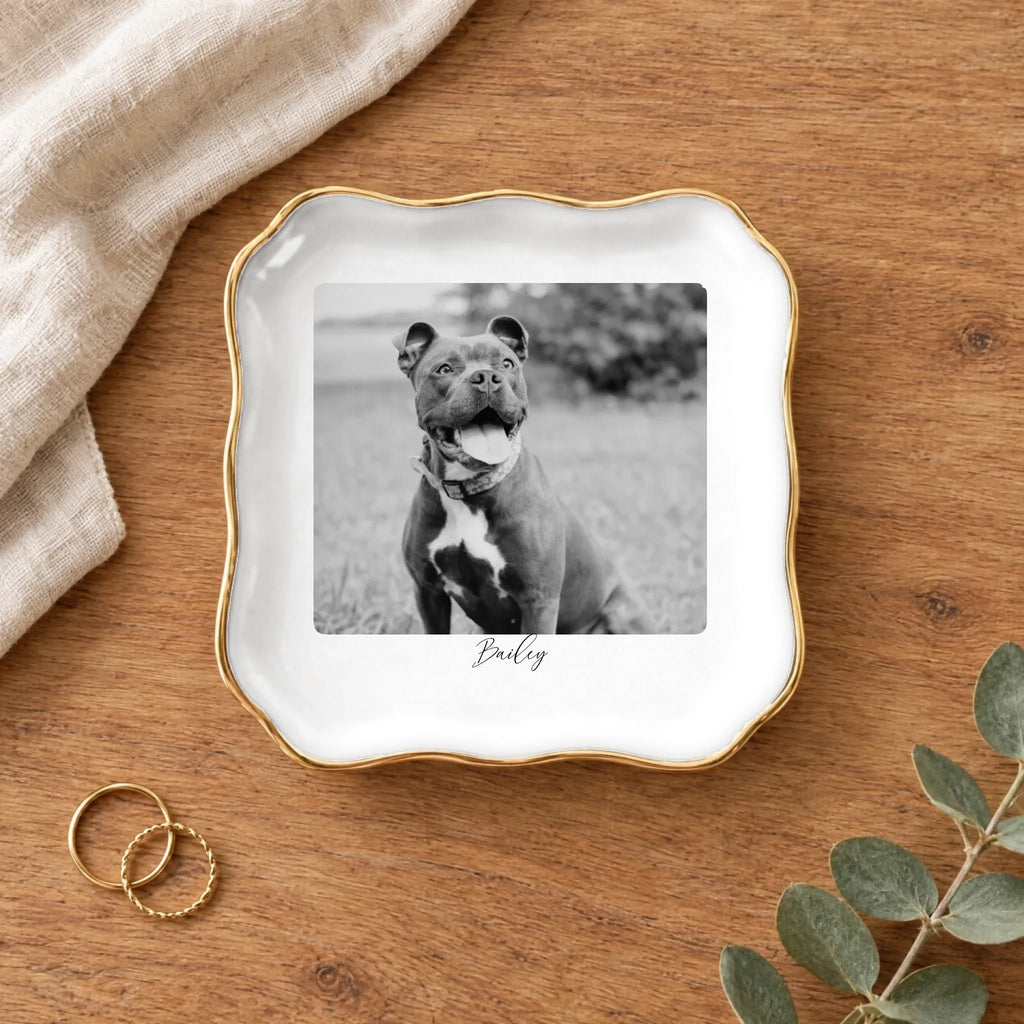 Black and white pet photo wavy square ring dish on a wooden table with linen and eucalyptus