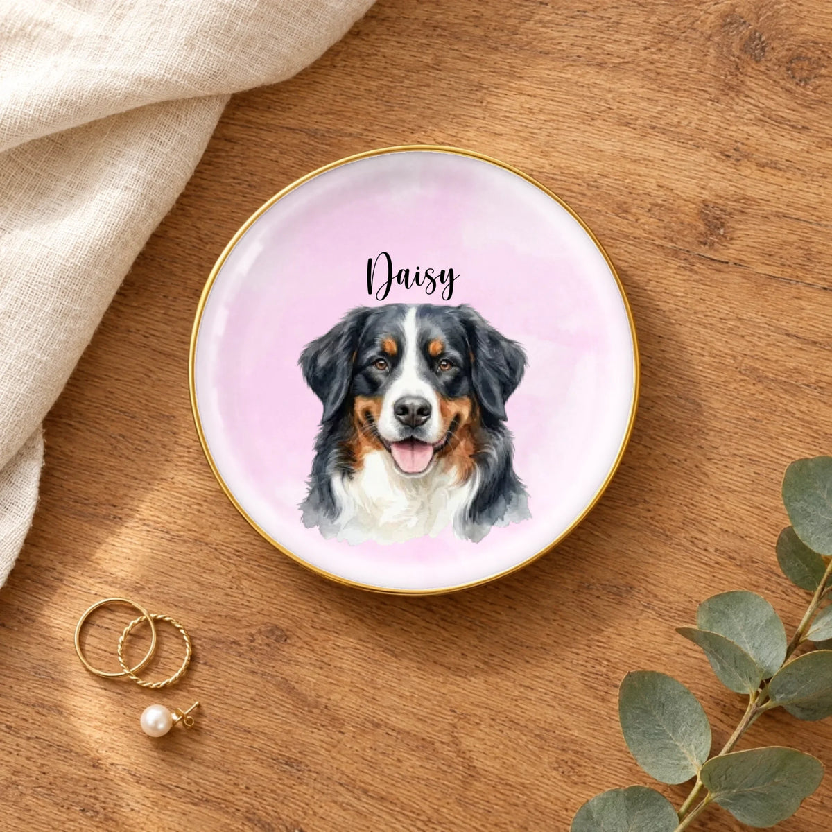 Personalized watercolor pet portrait round ring dish on a wooden table with linen, eucalyptus and gold rings