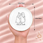 Hand holding a line drawing person and dog round ring dish, 3.9 inches across