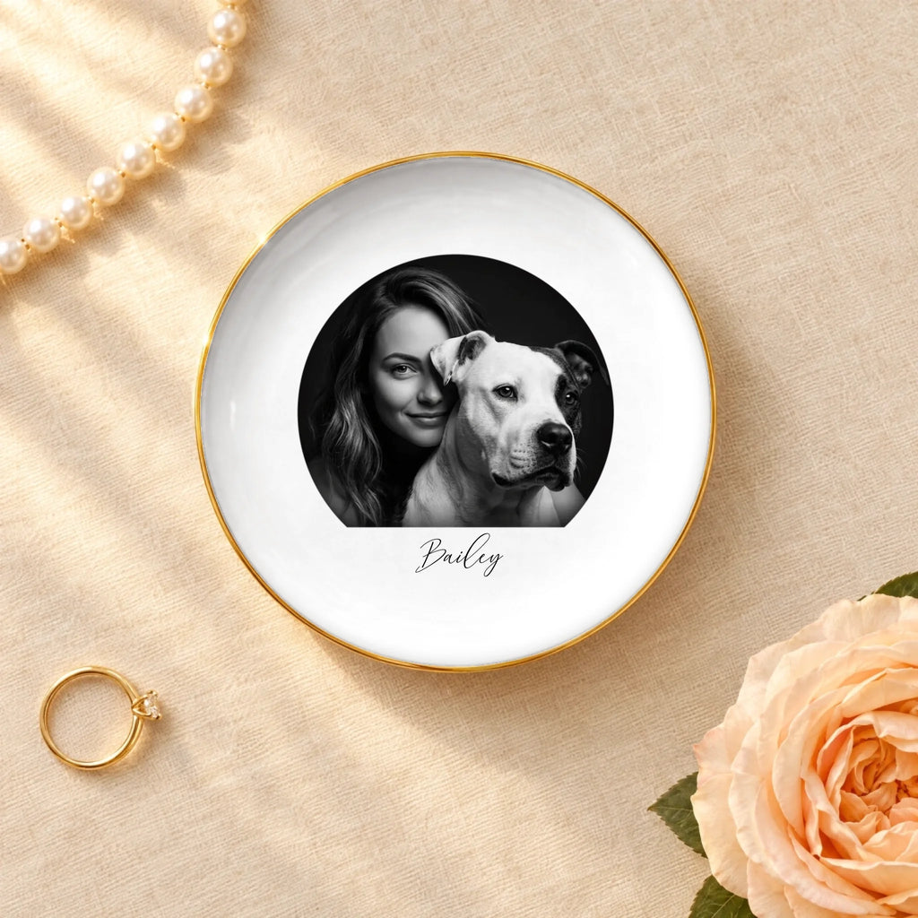Black and white studio portrait of owner and pet on a round ceramic ring dish with gold rim