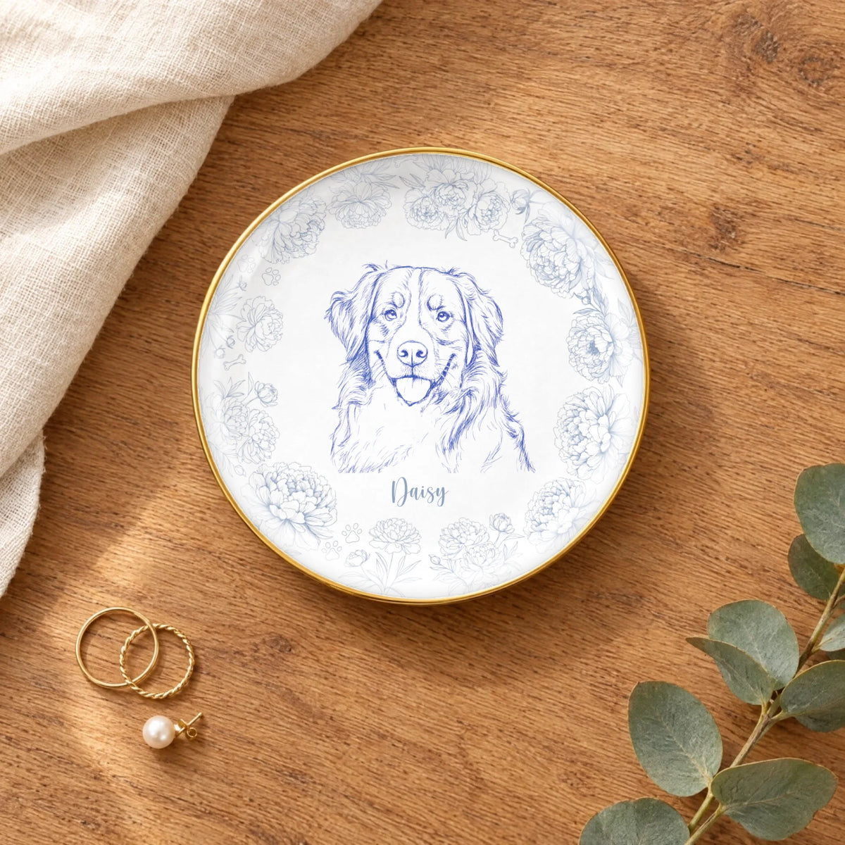 Round floral pet sketch ring dish styled on a wooden table with linen