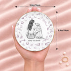 Hand holding a vintage sketch person and pet round ring dish, 3.9 inches across