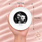 Hand holding a black and white studio portrait round ring dish, 3.9 inches across