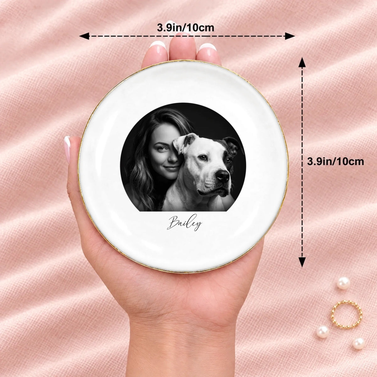 Hand holding a black and white studio portrait round ring dish, 3.9 inches across