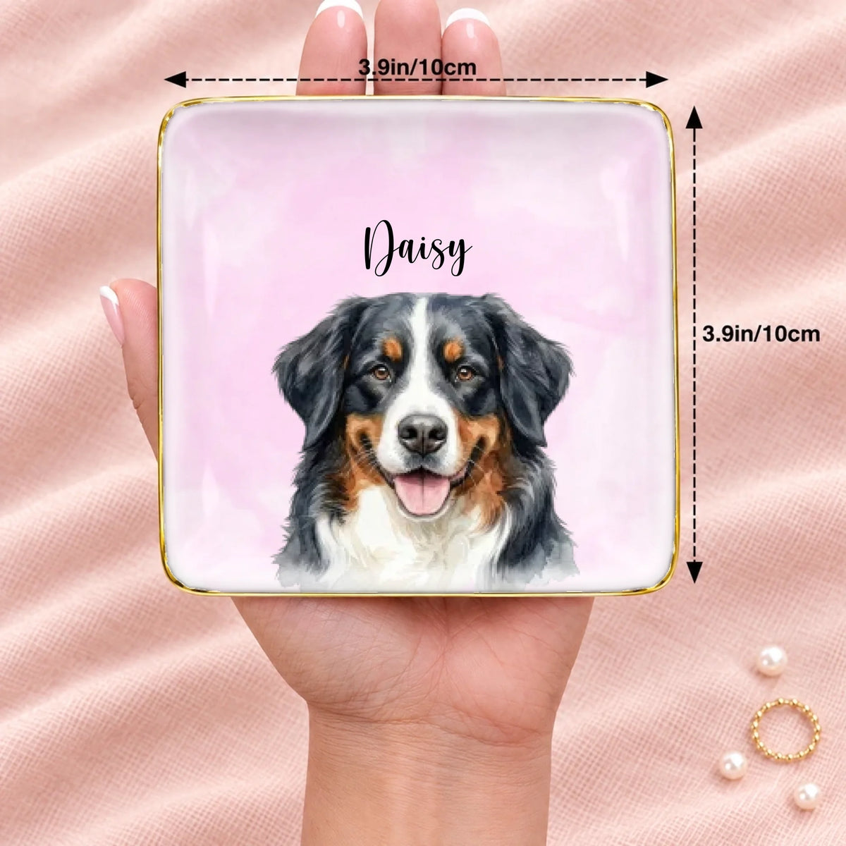 Personalized pet portrait square ring dish resting on an open hand, 3.9 inches across