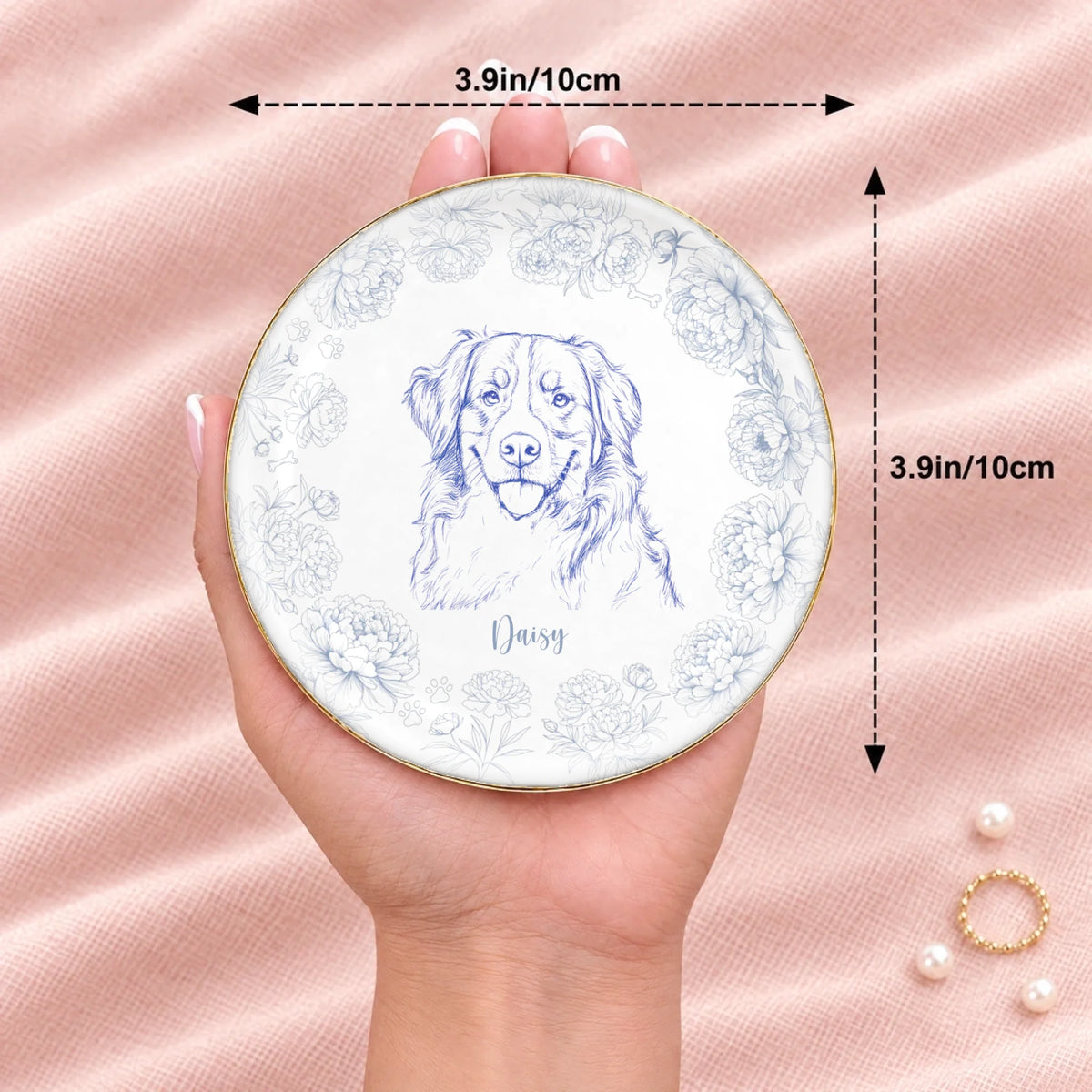 Round floral pet sketch ring dish resting on an open hand, 3.9 inches across