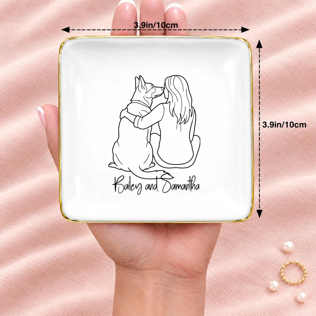 Line drawing person and dog square ring dish resting on an open hand, 3.9 inches across