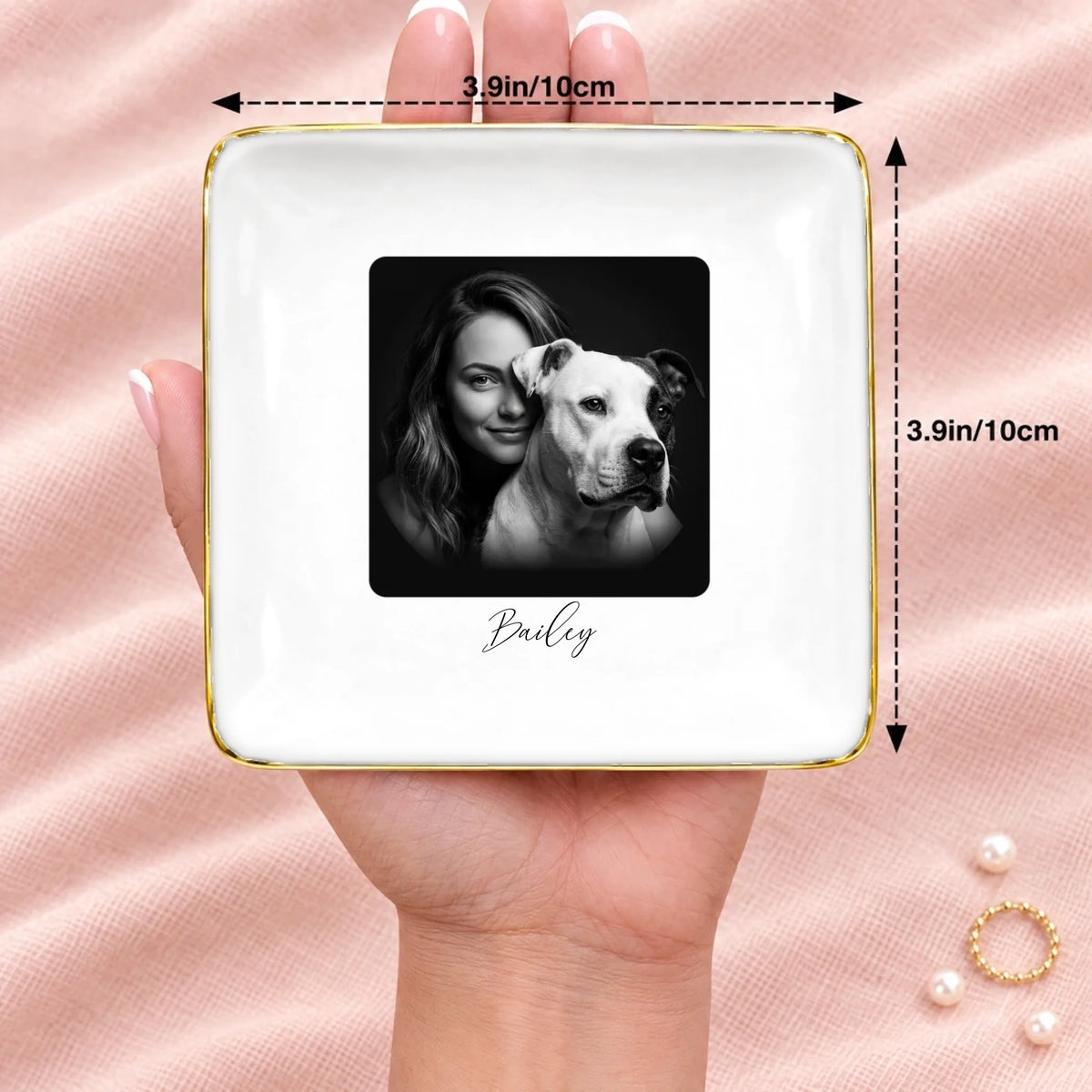 Black and white studio portrait square ring dish resting on an open hand, 3.9 inches across