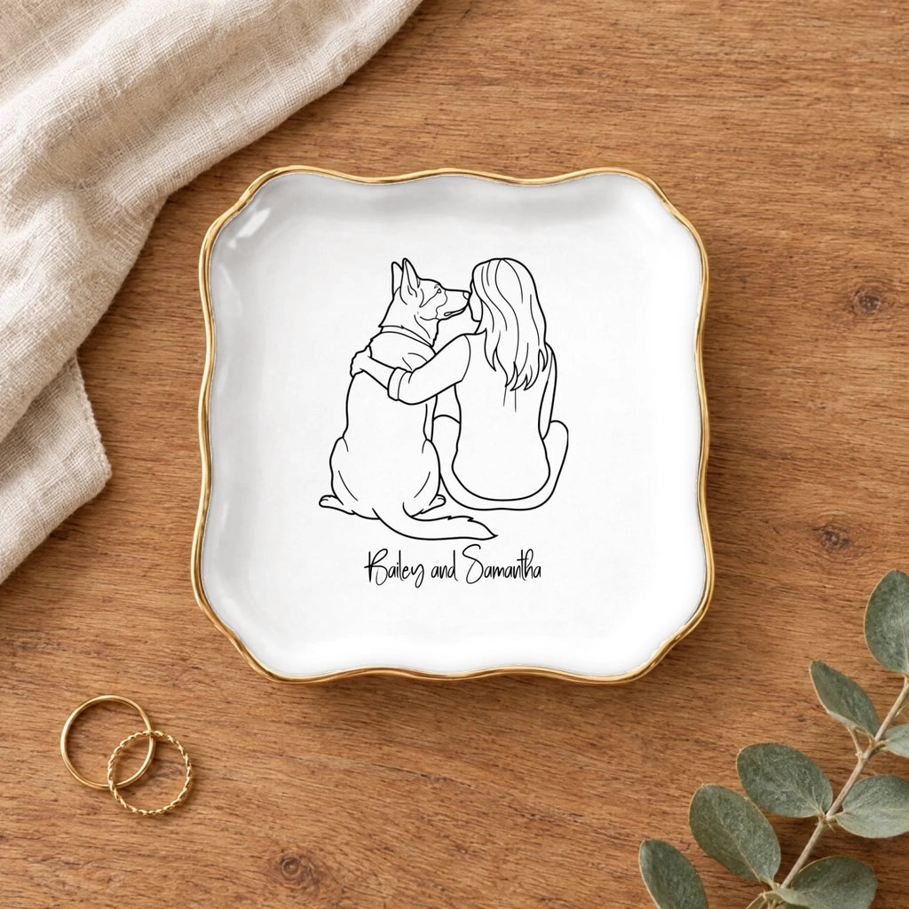 Line drawing person and dog wavy square ring dish on a wooden table with linen and eucalyptus