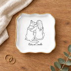 Line drawing person and dog wavy square ring dish on a wooden table with linen and eucalyptus