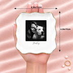 Hand holding a black and white studio portrait wavy square ring dish, 4.1 inches across