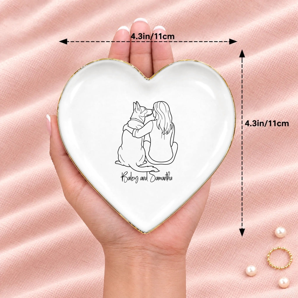 Hand holding a line drawing person and dog heart ring dish, 4.3 inches across