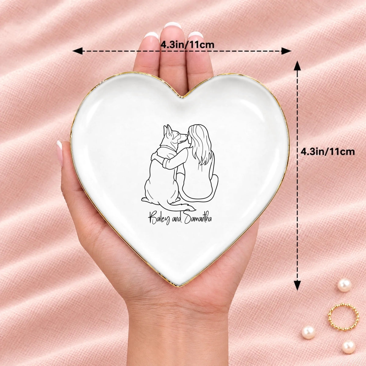 Hand holding a line drawing person and dog heart ring dish, 4.3 inches across