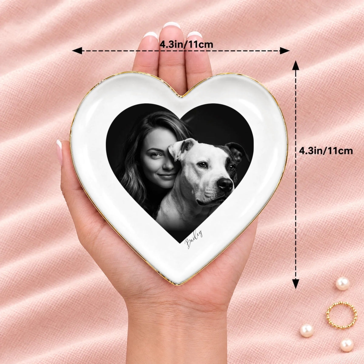 Hand holding a black and white studio portrait heart ring dish, 4.3 inches across