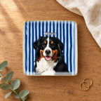 Square striped pet portrait ring dish on a wooden table with linen and eucalyptus