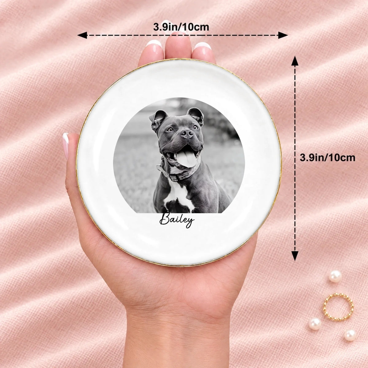 Hand holding a black and white pet photo round ring dish, 3.9 inches across