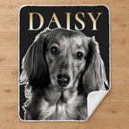 Personalized black and white pet portrait sherpa blanket with name, laid flat on an oak floor