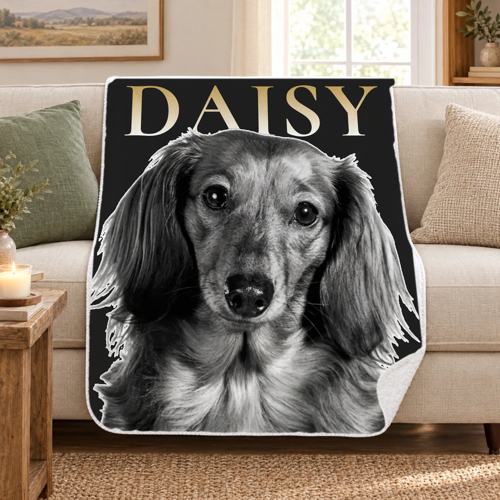 Personalized black and white pet portrait sherpa blanket draped over a cream sofa