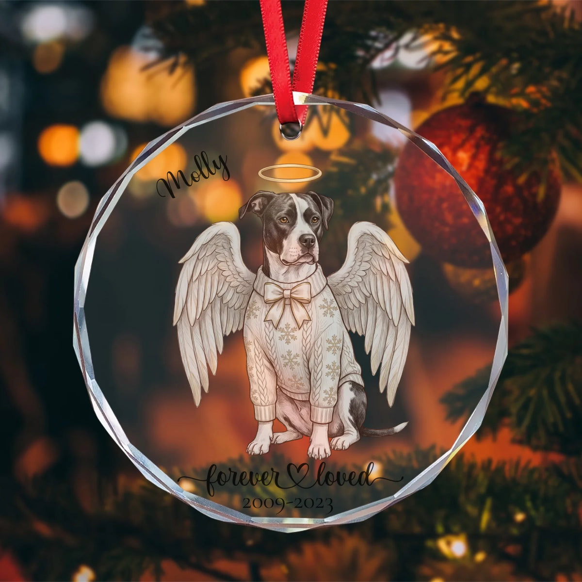 Pet angel glass ornament hanging on a Christmas tree with warm lights