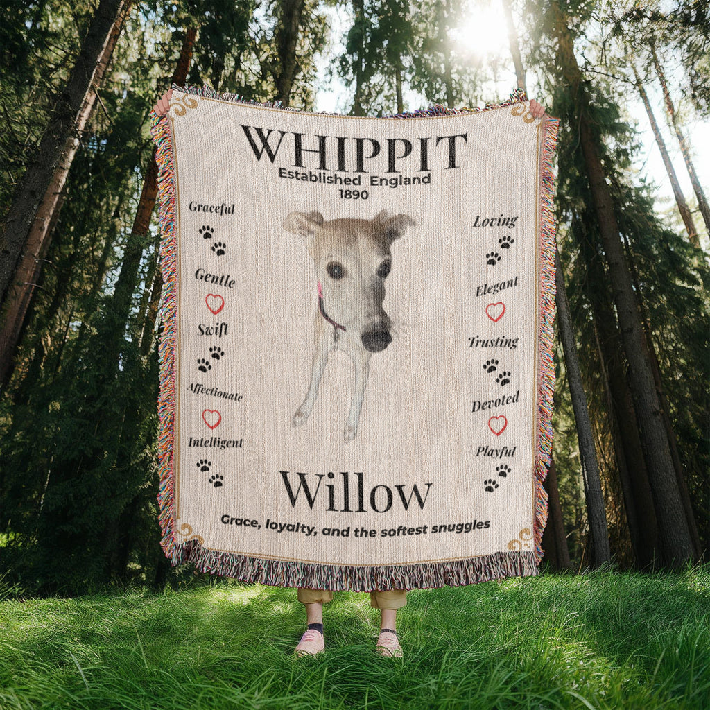 Person holding a blanket with a whippet design and text in a forest. Personalize your Whippit woven blanket with your favorite photo and your dog's name.