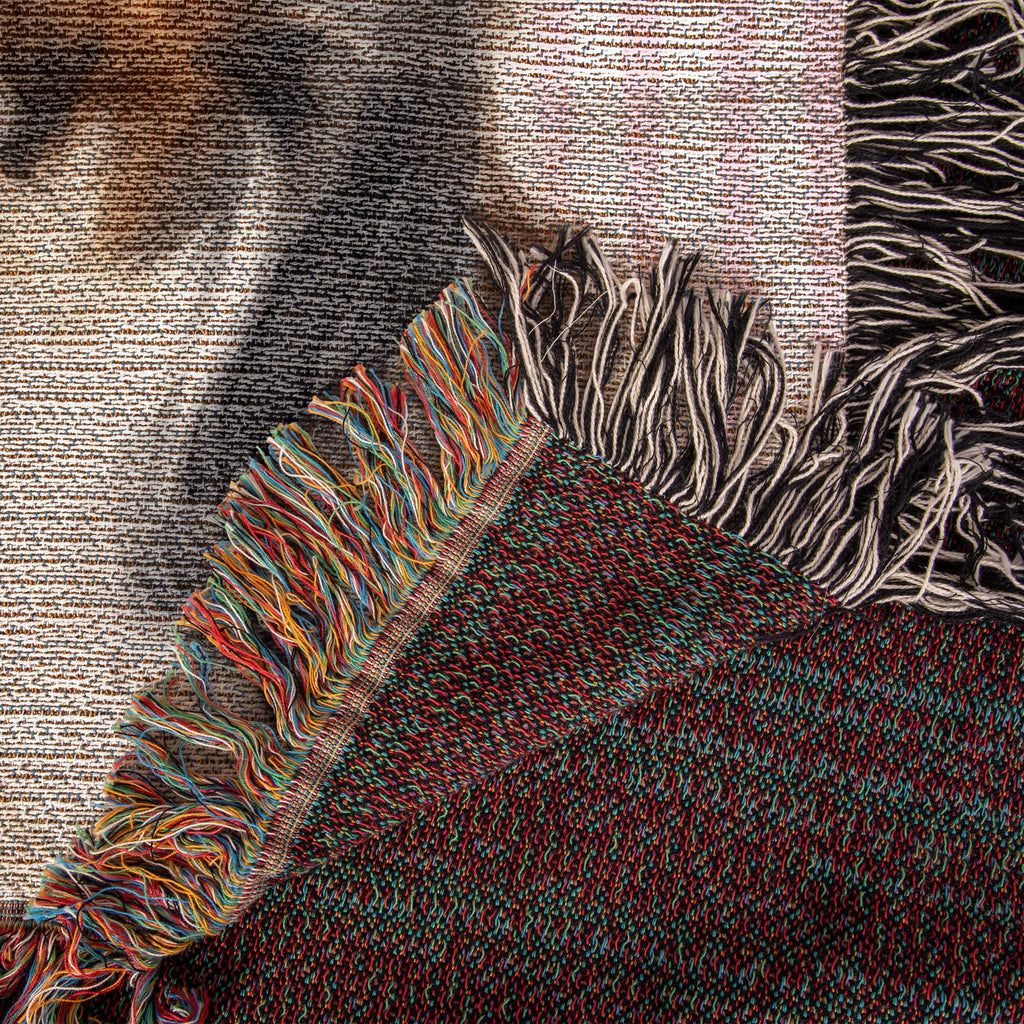 Close-up of a textured fabric with colorful fringes on a neutral background