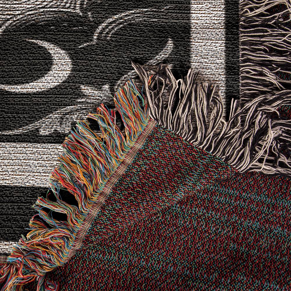 woven Textured fabric with colorful fringe against a black and white patterned background