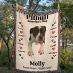woven Blanket with a Pitbull illustration and text about the breed, hanging outdoors.