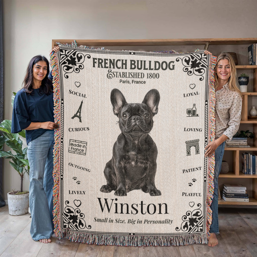Two people holding a French Bulldog-themed woven blanket with the name 'Winston'.Personalized with the name and photo of your Frenchie.