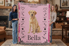 Two women holding a pink Labrador Retriever-themed blanket with the name 'Bella' on a wooden floor.Personalize your woven blanket with your favorite Labrador's photo and Name.