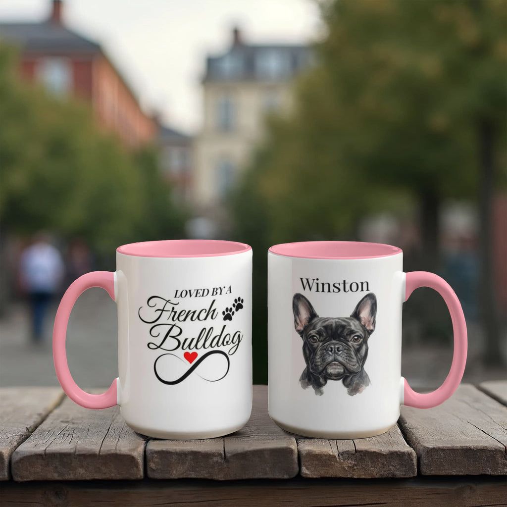 Two mugs with pink interiors and handles on a wooden surface, one featuring text and the other a dog illustration.