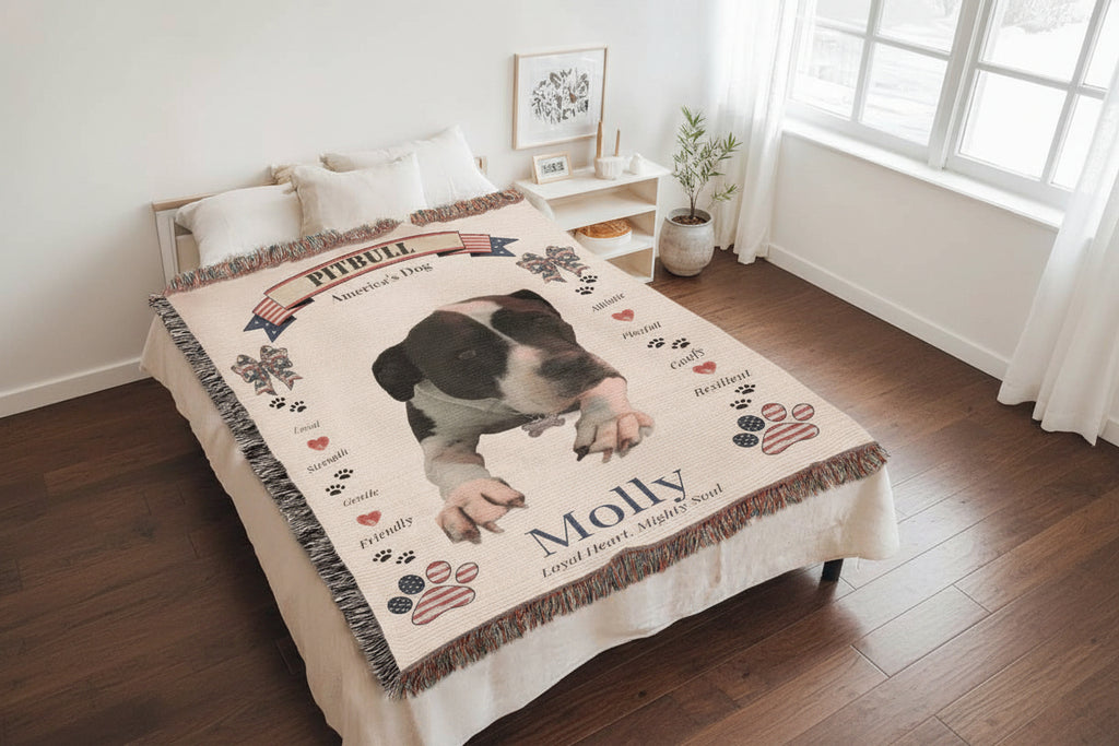 Blanket with a dog illustration and text on a bed in a room. Personalize your favorite picture of your Pitte on this custom woven blanket with their name.