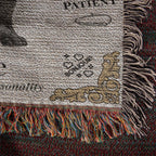 Textile with fringes and printed text on a dark background