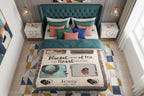 Personalized pet memorial blanket with photos and text on a bed in a room.