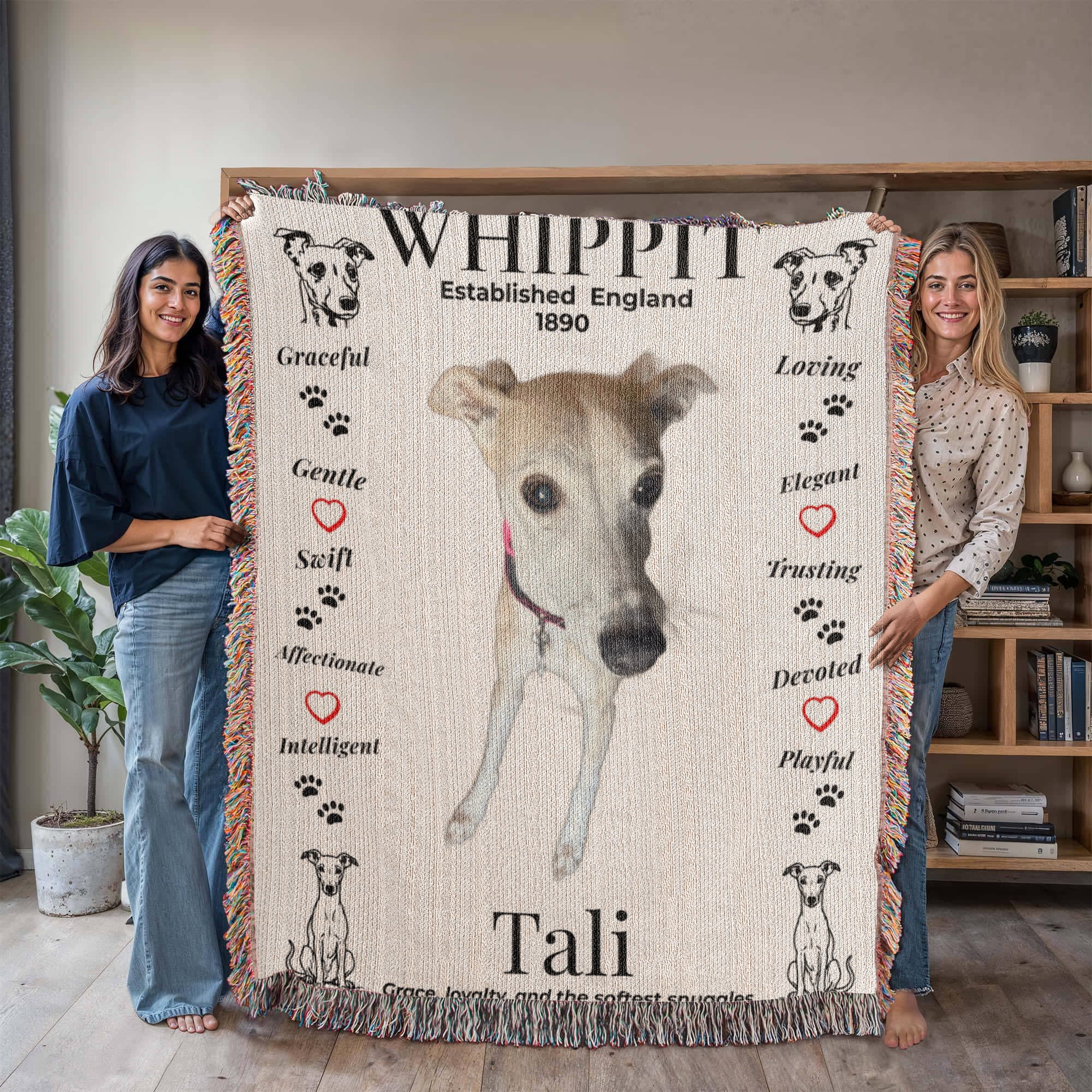 Two women holding a blanket with a whippet design and text. Personalize your woven blanket with your favorite photo of your Whippit.